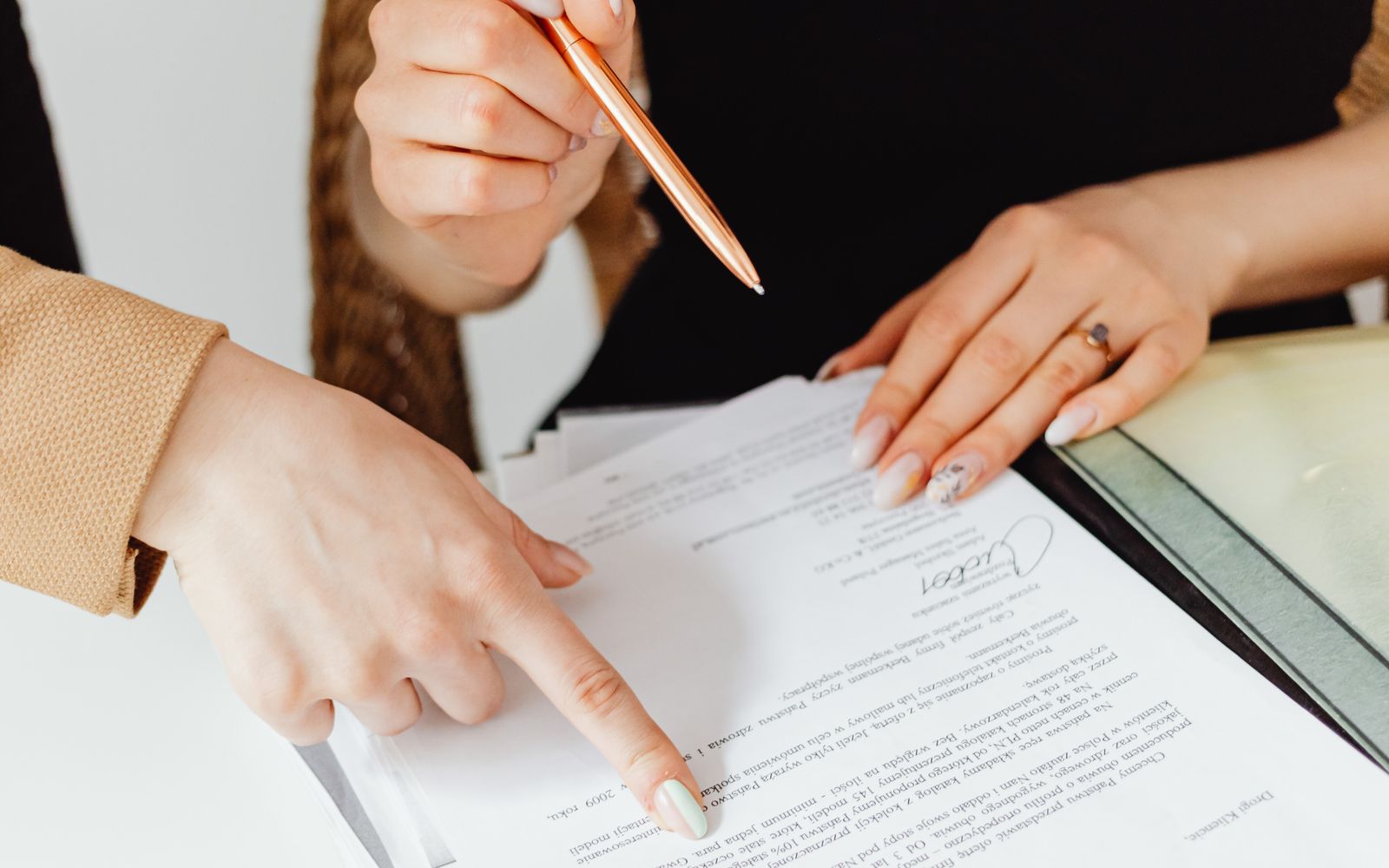 Two people going through printed paperwork together