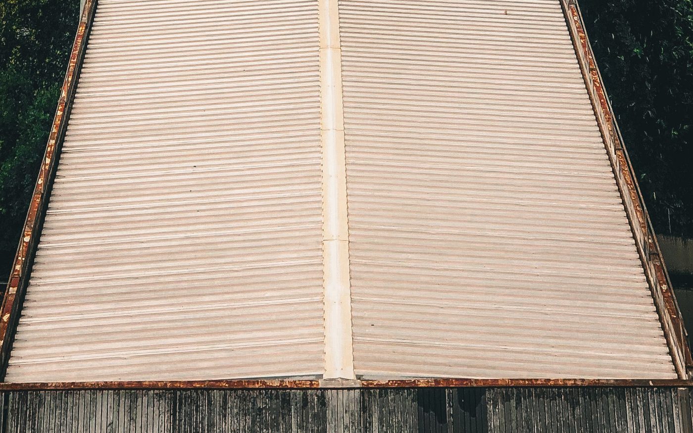 Long weathered low-slope roof seen from above