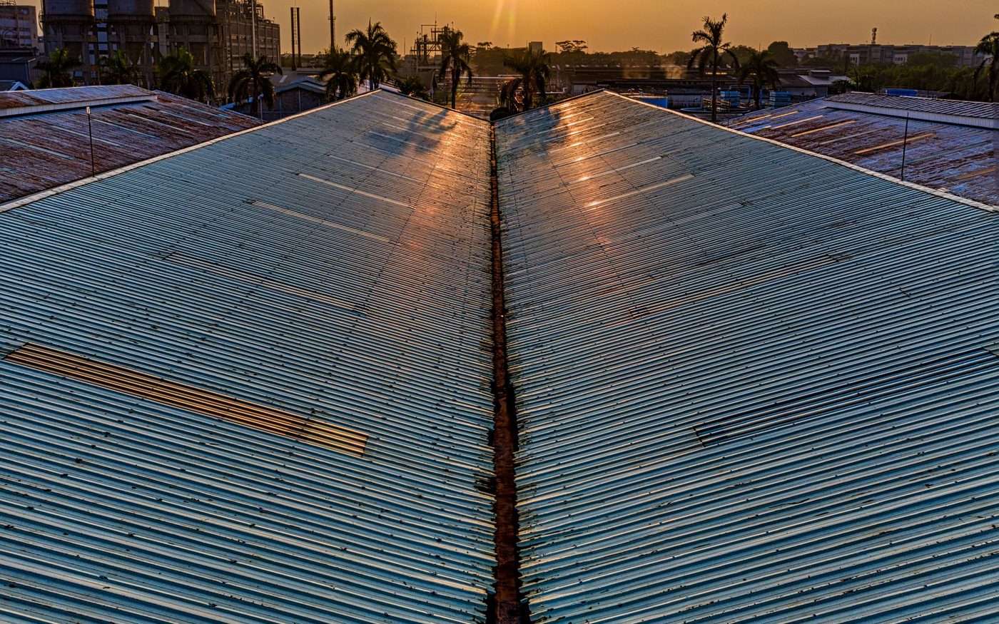 Industrial metal roofs at sunset