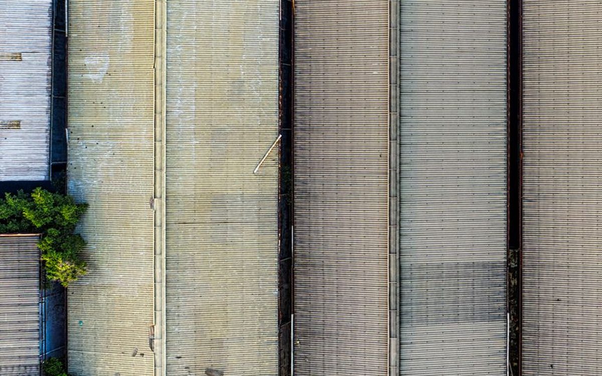 Long roof strips edged with trees, seen from above