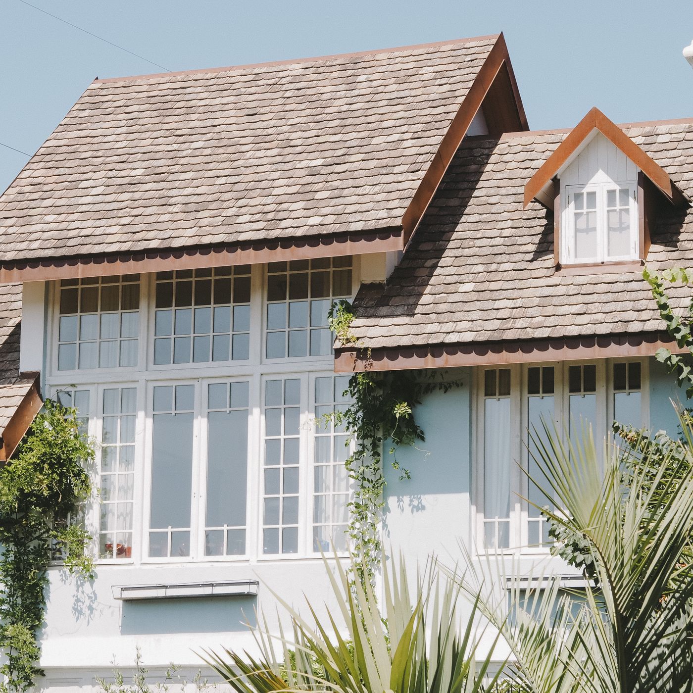 Steep shingle roof with gabled dormers