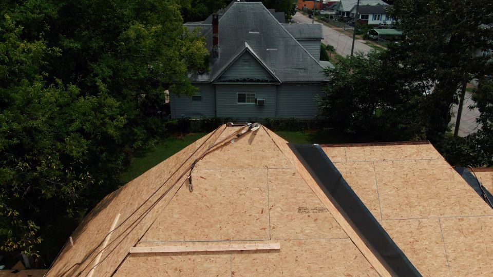 Bare roof decking exposed during a tear-off, seen from above