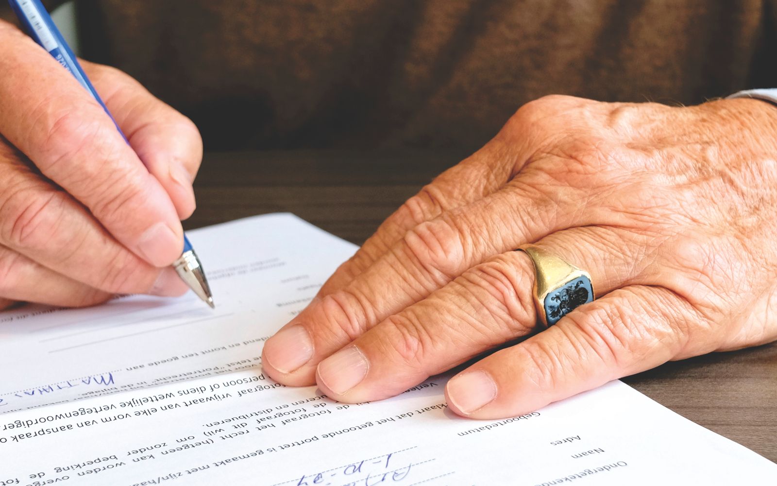 Person signing a printed document