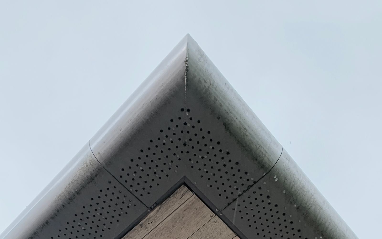 Perforated vent strip running along a timber soffit