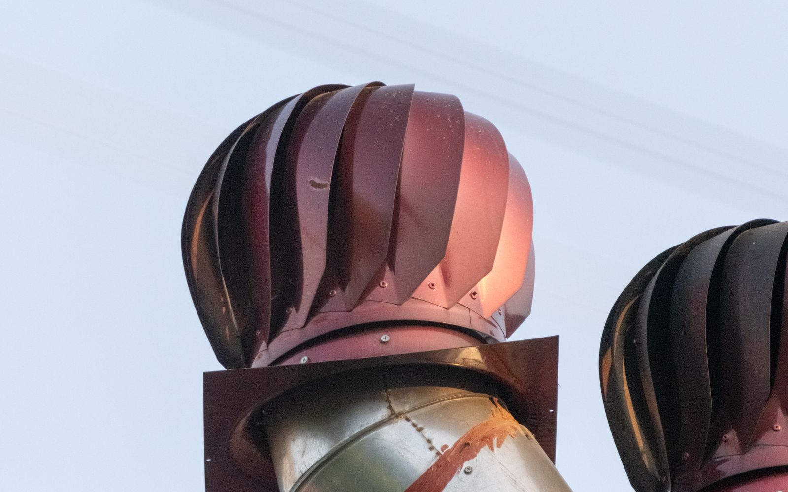 Two turbine vents on a roof, where attic air leaves