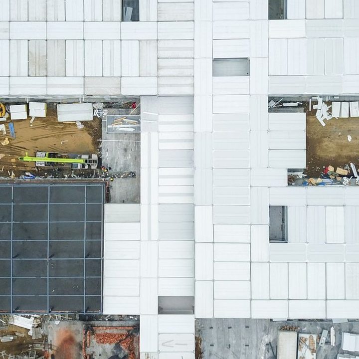 White roof sections and a dark solar array seen from above