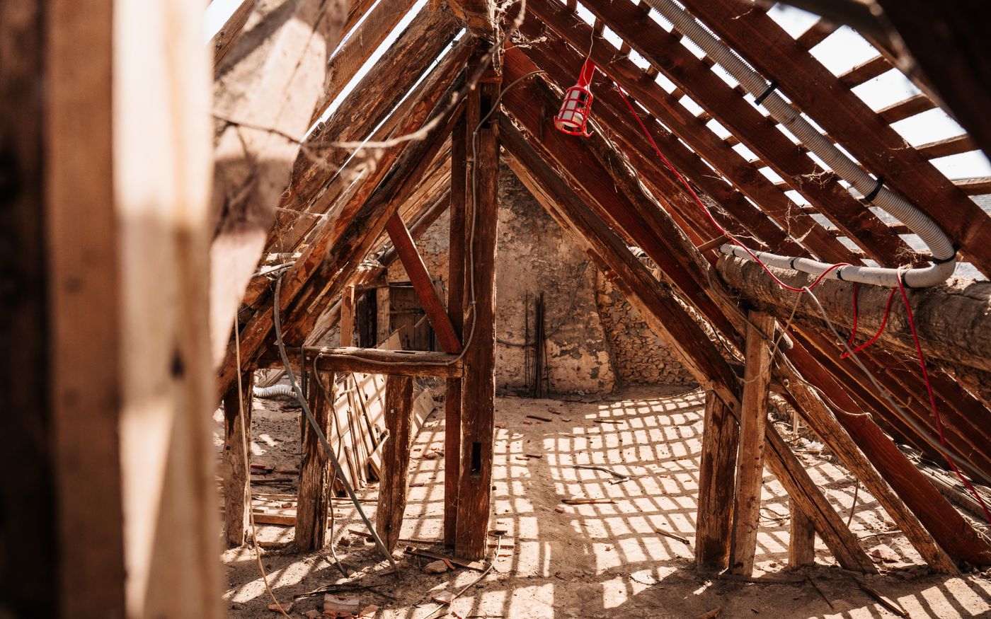 Daylight showing through gaps in the roof boards of an attic