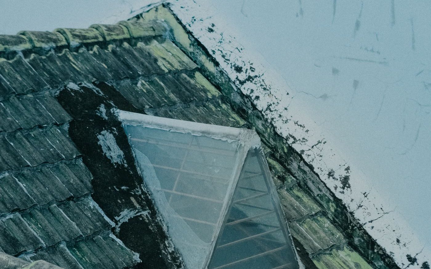 Weathered skylight set into an old tile roof