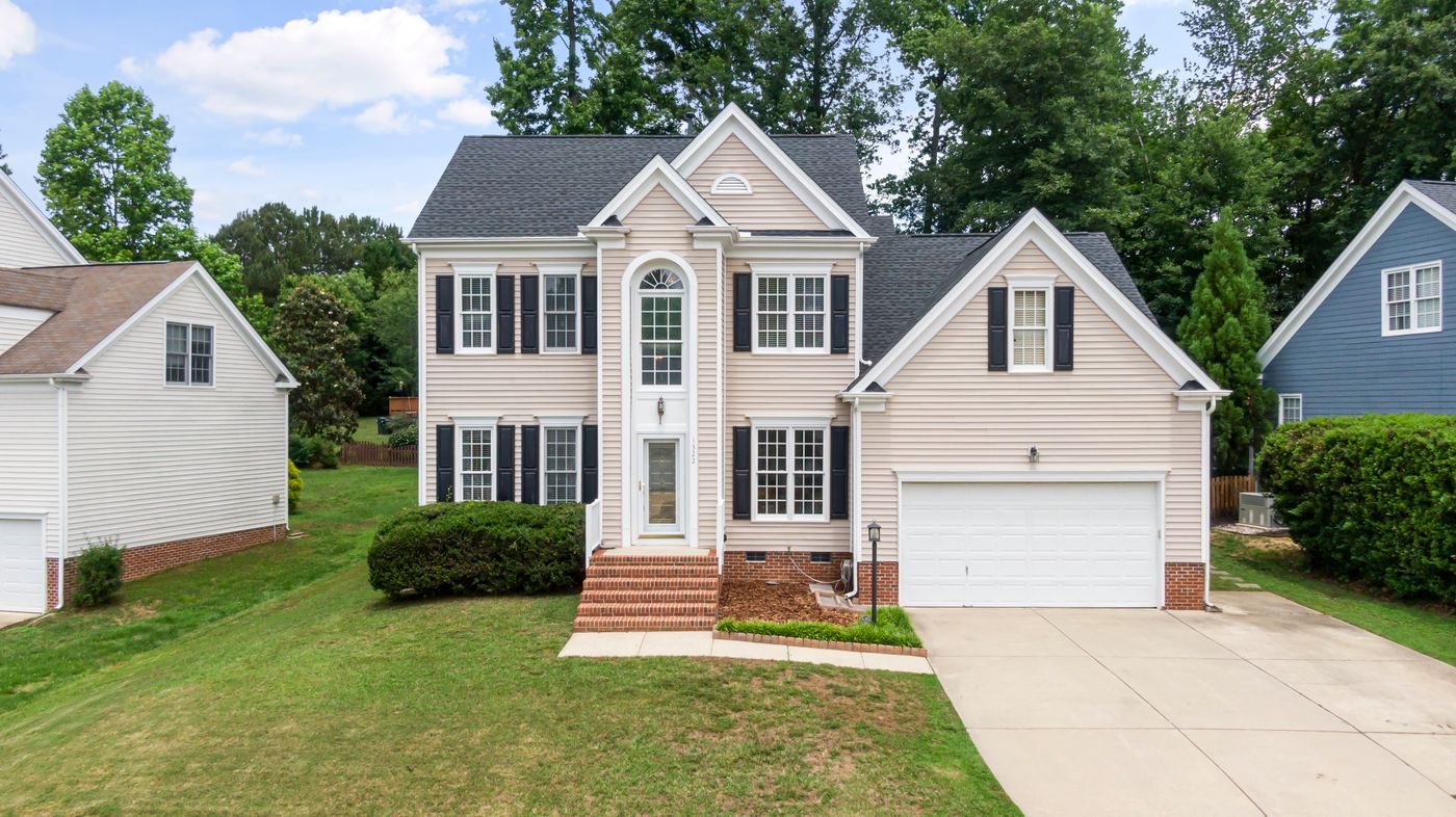 Two story house with a front lawn and a double garage