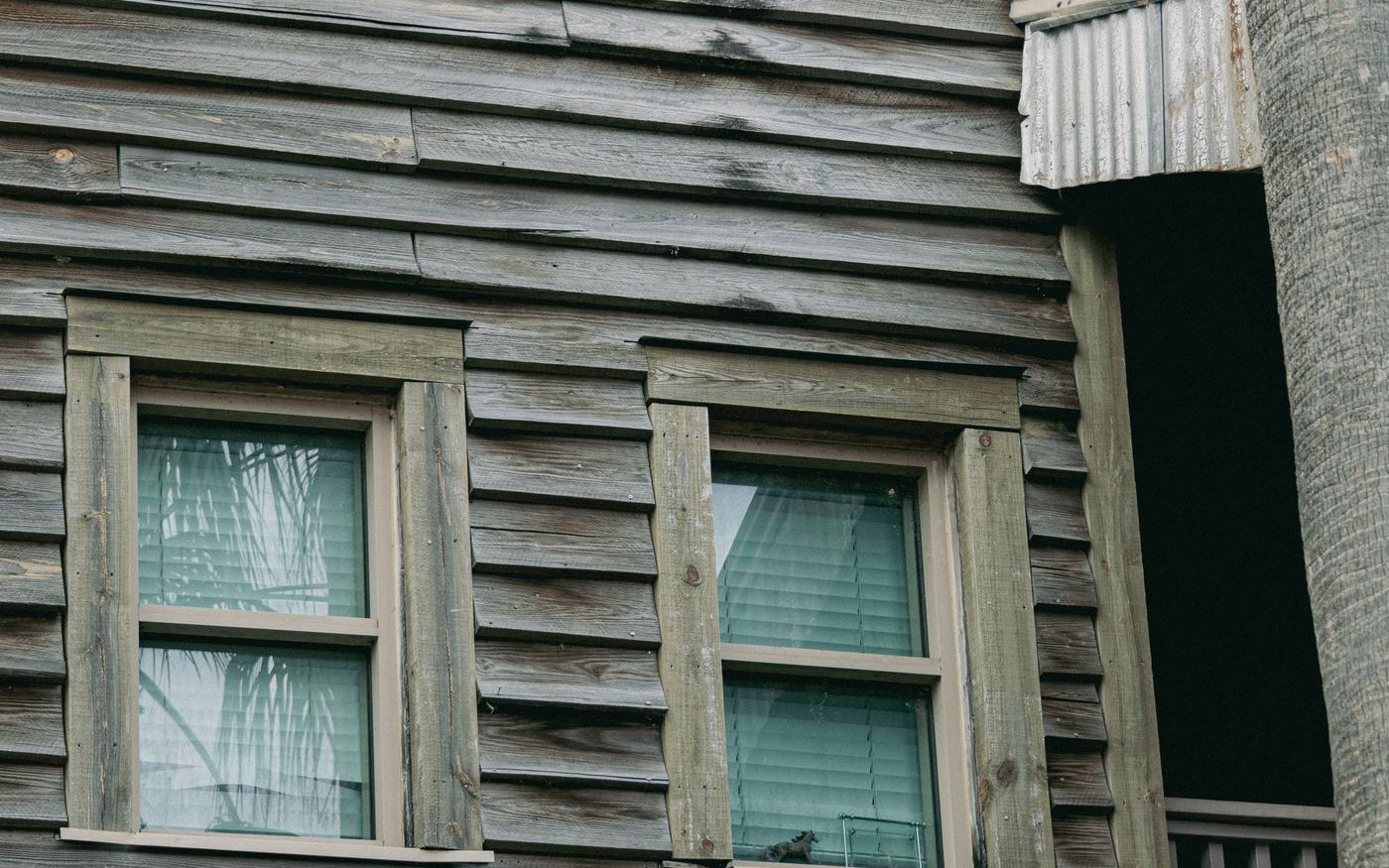 Weathered, warped horizontal boards on the side of a house