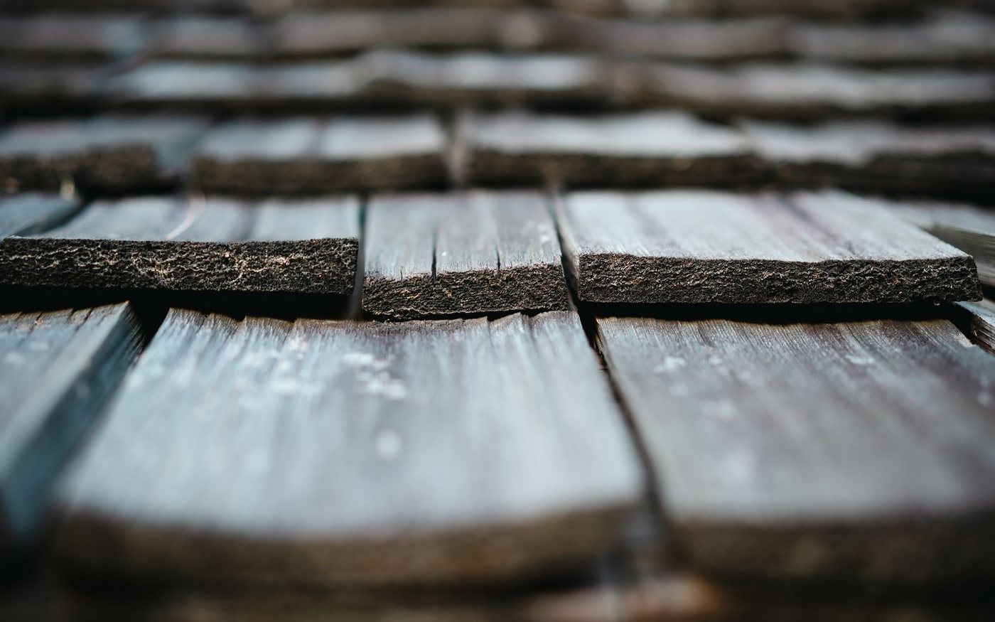 Split, weathered wooden shakes up close