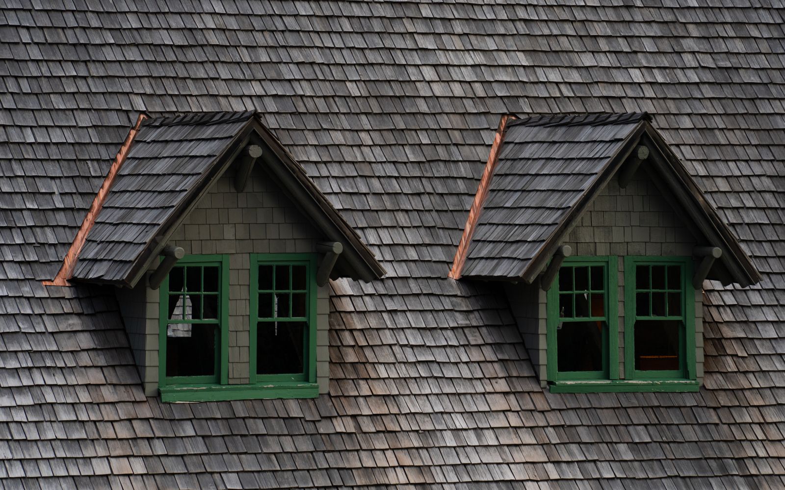 Aged cedar shake roof with two dormer windows