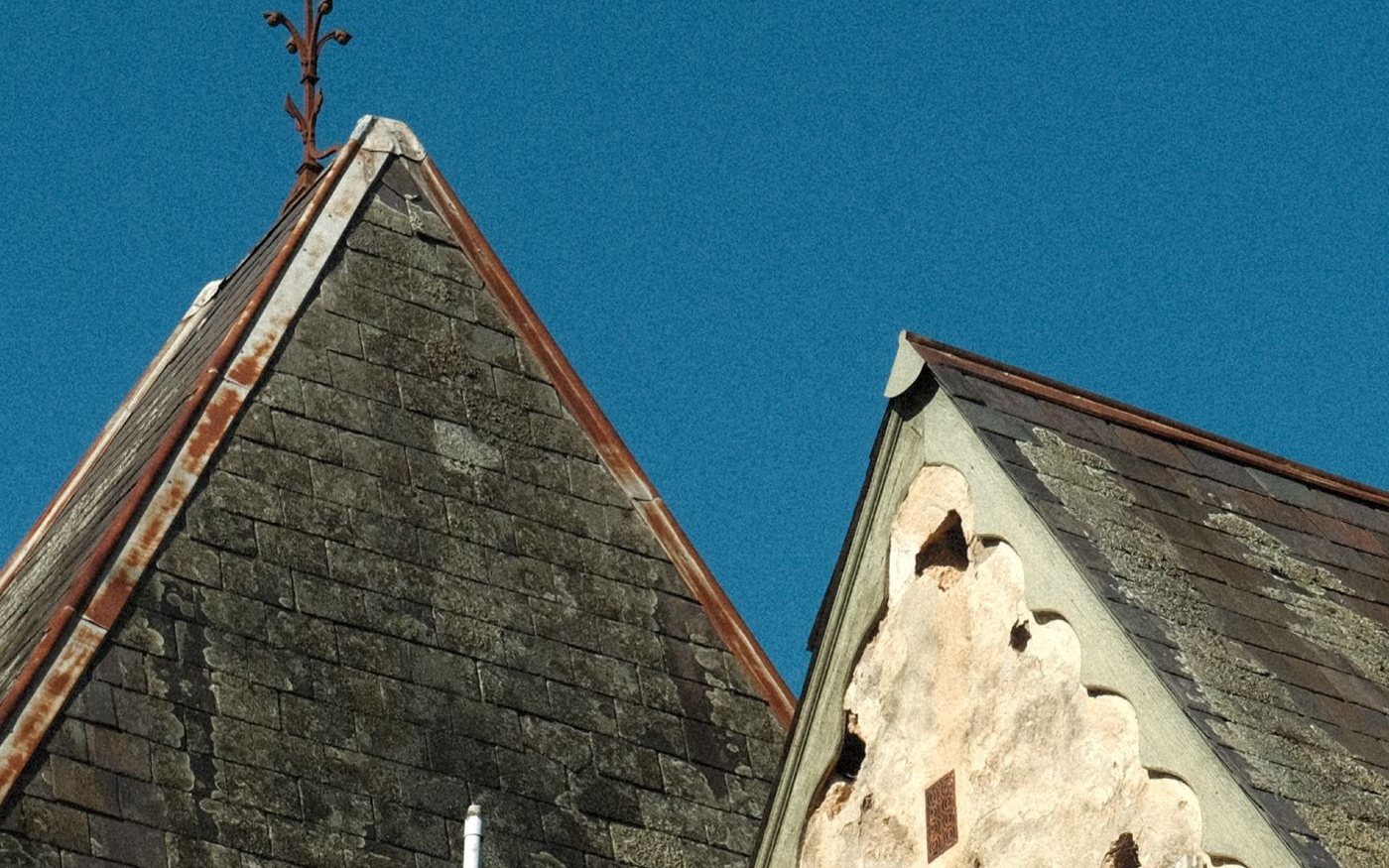 Two steep gables, one covered in old slate