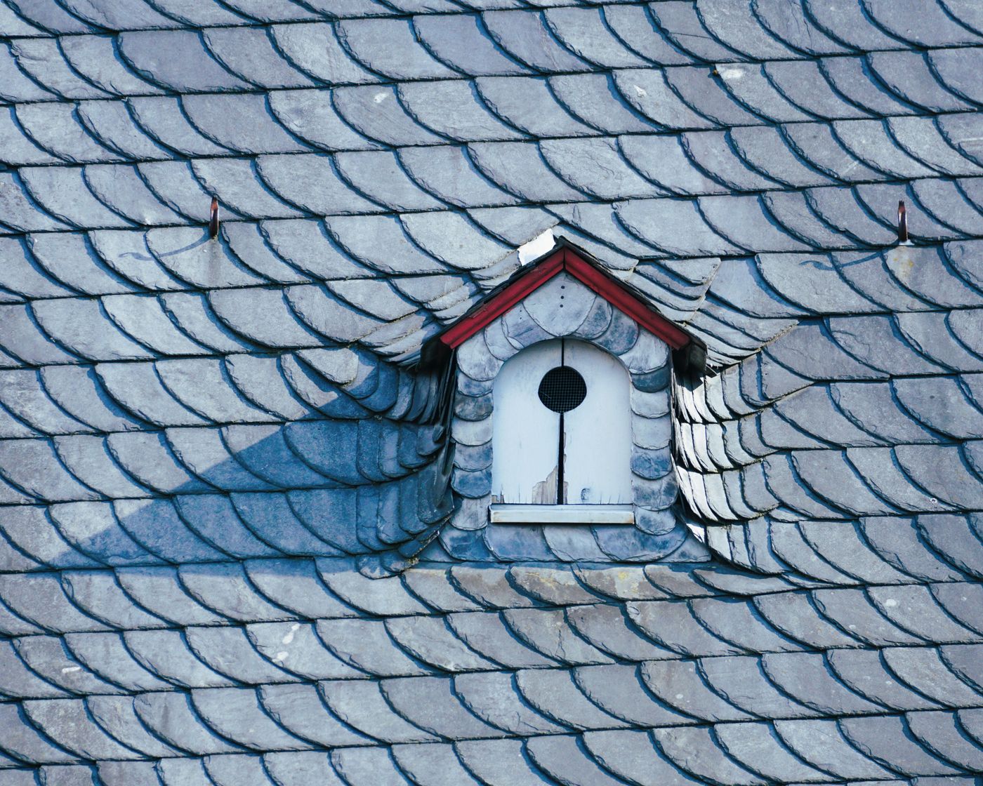 Blue gray slate roof with a dormer window