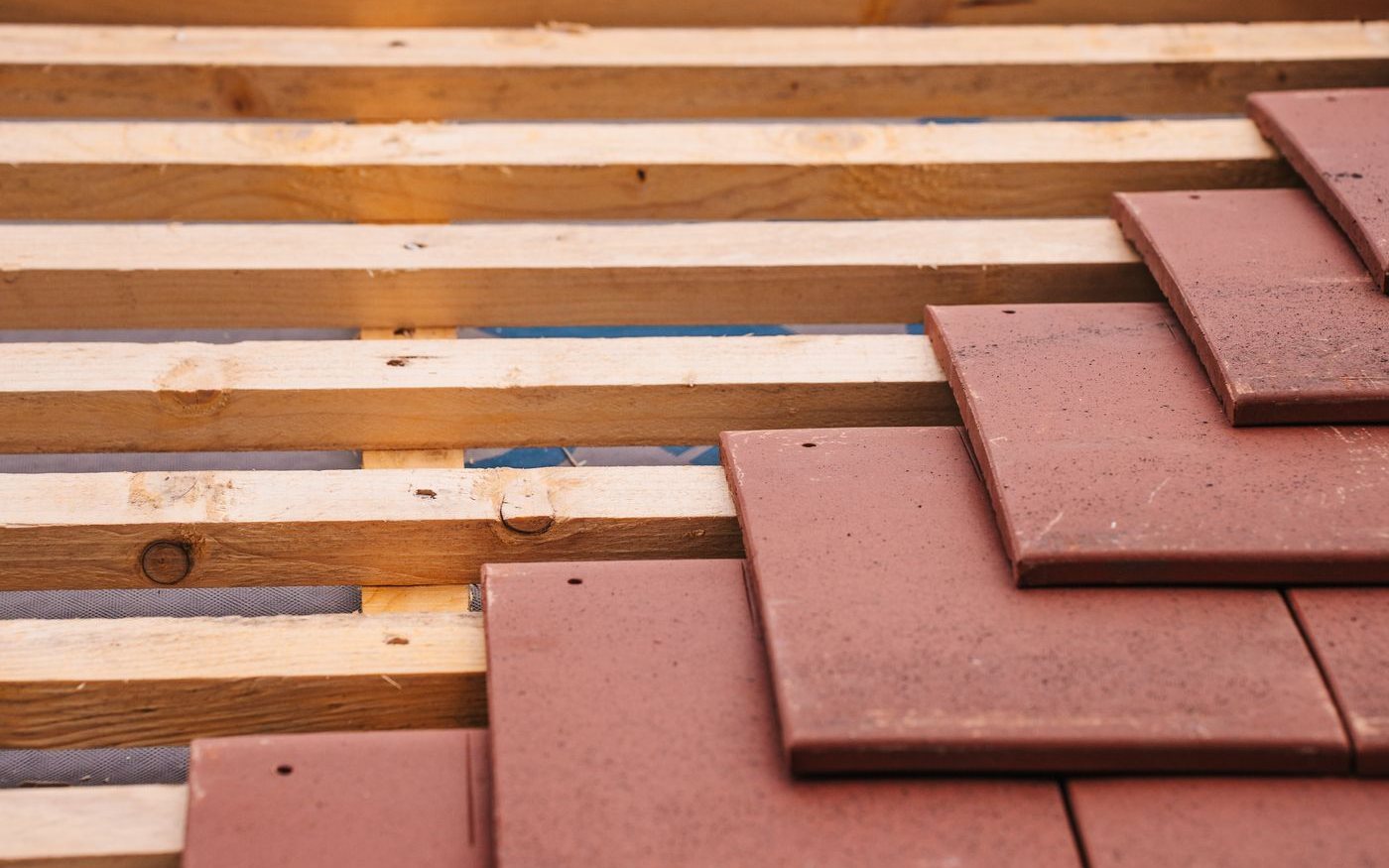 Flat clay tiles laid over wooden battens